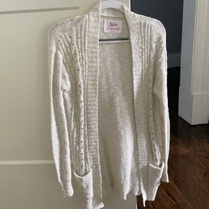 A white sweater with silver and and gold sequins